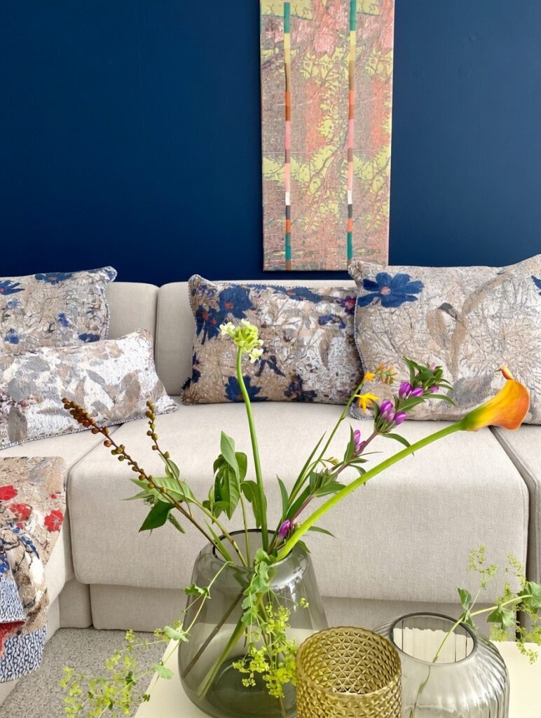kussens op bank met vaas bloemen op de voorgrond